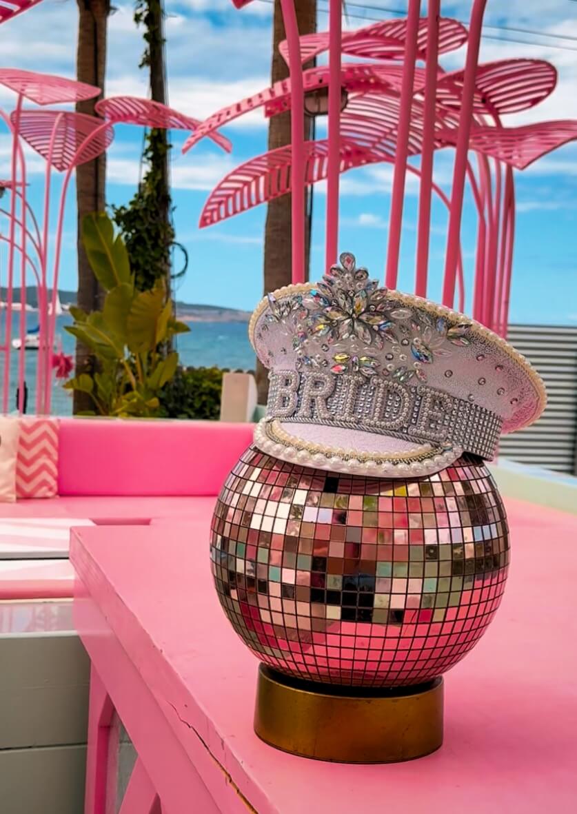 Sparkling Ibiza bridal party accessory – unique “Bride” hat and disco ball detail photo.