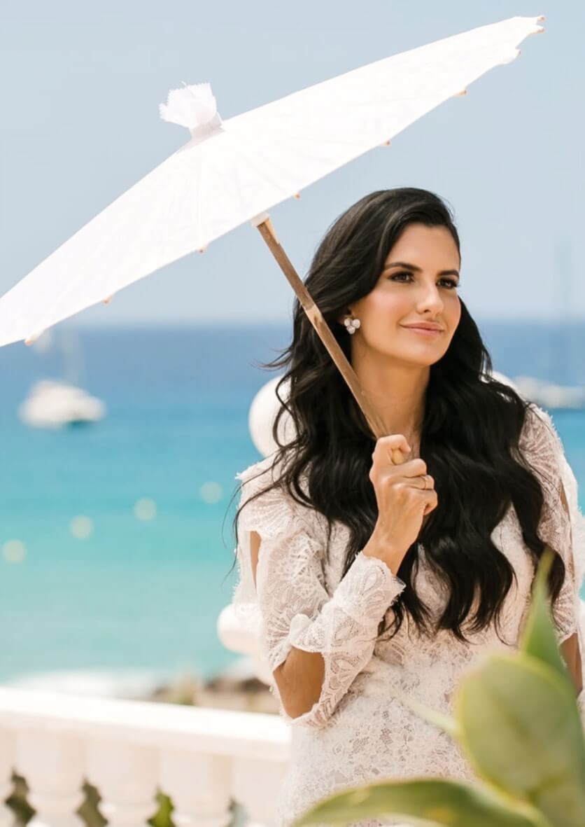 Bride in Ibiza with parasol – romantic beach wedding photography capturing Mediterranean charm.